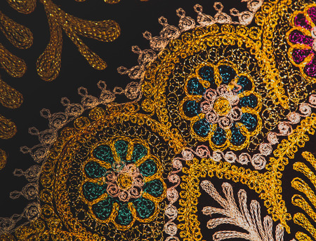 Golden Uzbek ornament on textileの写真素材