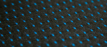 Blue dots on black textileの写真素材