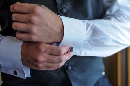 man wear a white shirt and cuff linksの写真素材