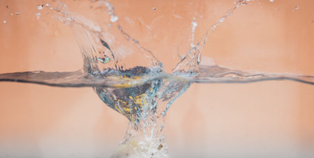 An Apple dip in aquarium with water splashesの写真素材