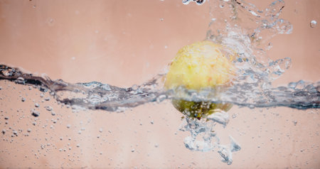 An Apple dip in aquarium with water splashes