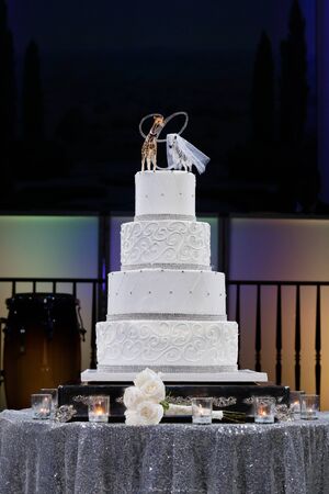 White Wedding Cake on the brides' and groom's tableの写真素材