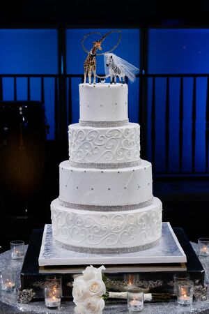 White Wedding Cake on the brides' and groom's tableの写真素材