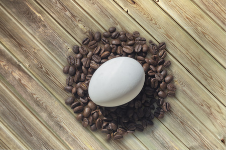 Coffee beans and Easter egg, on wooden background. Easterの写真素材