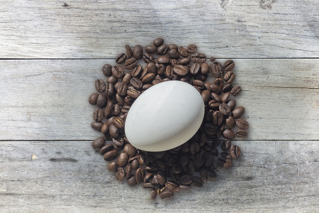 Coffee beans and Easter egg, on wooden background. Easterの写真素材