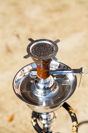 Big hookah for tobacco smoking made of metal, glass and ceramics.