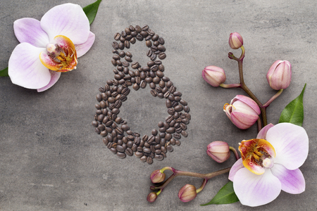 Coffee beans in form of number 8 and orchids on beautifull background. International women's day. 8th marchの写真素材
