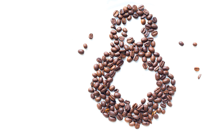 Coffee beans in form of number 8 and orchids on white plastic plate. International women's day. 8th marchの写真素材