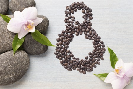 Coffee beans in form of number 8 and orchids on beautifull background. International women's day. 8th marchの写真素材
