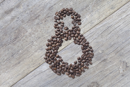 Coffee beans in form of number 8 and on beautifull wooden background. International women's day. 8th marchの写真素材