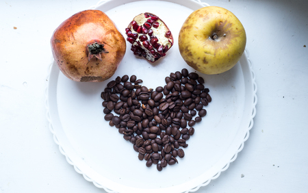 Coffee beans in form of heart on beautifull background. Love. Insparation. Romantic. On white plate.の写真素材