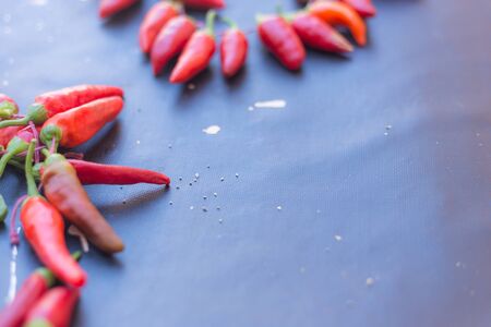 From above pile of red pepper placed on dark board background.の写真素材