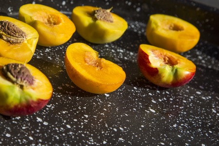 Background of peaches halves on marble surface.の写真素材