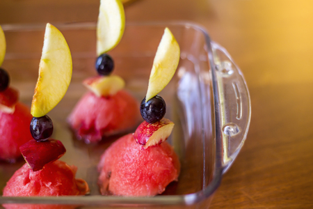 Close-up tray with canape snacks made with watermelon, apple, and grapes.の写真素材
