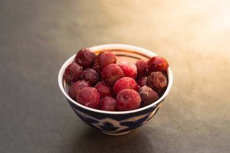 From above small bowl with frozen cherry berries on dark background.の写真素材