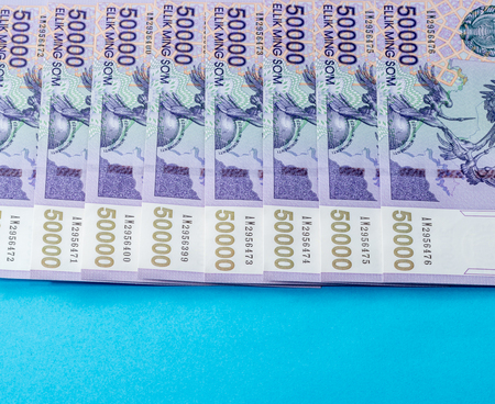 Uzbek banknotes on blue background. Currency. Uzbek Money. Fifty Thousand Uzbek Sums 50000の写真素材