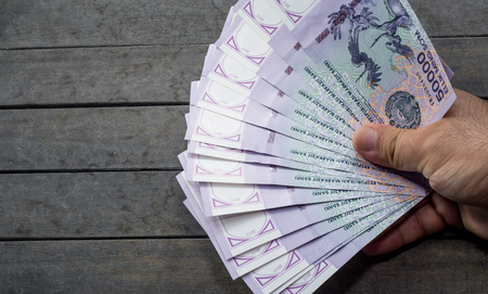Uzbek banknotes on wooden background. Currency. Uzbek Money. Fifty Thousand Uzbek Sums 50000の写真素材