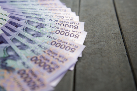 Uzbek banknotes on wooden background. Currency. Uzbek Money. Fifty Thousand Uzbek Sums 50000の写真素材