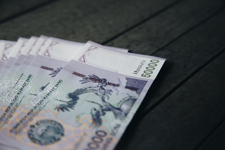 Uzbek banknotes on wooden background. Currency. Uzbek Money. Fifty Thousand Uzbek Sums 50000の写真素材
