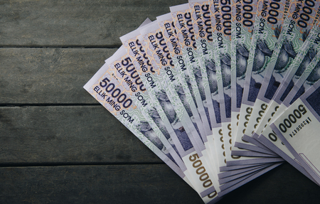 Uzbek banknotes on wooden background. Currency. Uzbek Money. Fifty Thousand Uzbek Sums 50000の写真素材