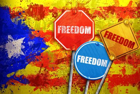 Political slogan in the form of traffic signs with Flag of Catalonia on the background. Signs with word FREEDOM. Independence of catalonia. Referernundum and protests in Catalonia, Barcelona.の写真素材