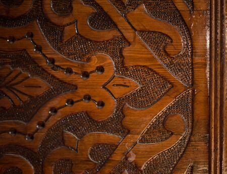 ornament work on dark wood. Horizontal view.の写真素材