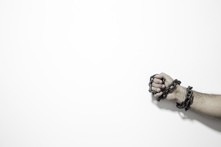 Human rights concept: chained man against white background.の写真素材