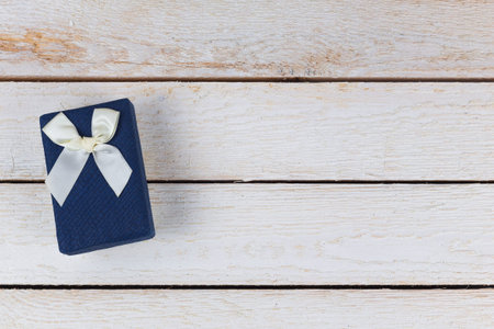 Blue Gift box on light wooden background. Top view. Copy spaceの写真素材