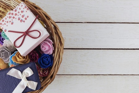 basket of spring flowers on light wooden background. Top view.の写真素材