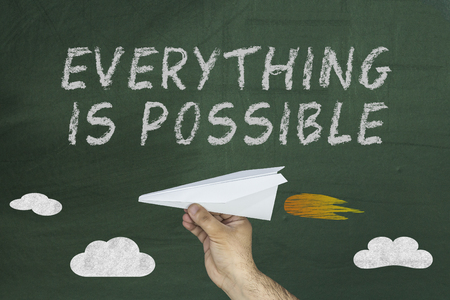 Everything is Possible message written on chalkboard with flying planeの写真素材