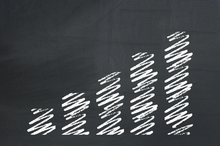 Growing hand drawn business chart on a blackboardの写真素材