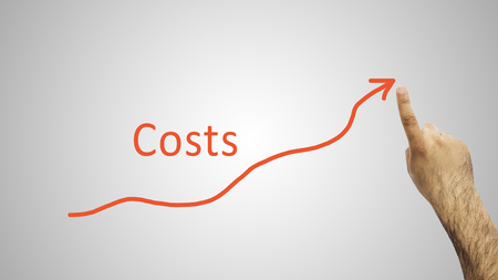 Hand indexing to the rise of costs on whiteboardの写真素材
