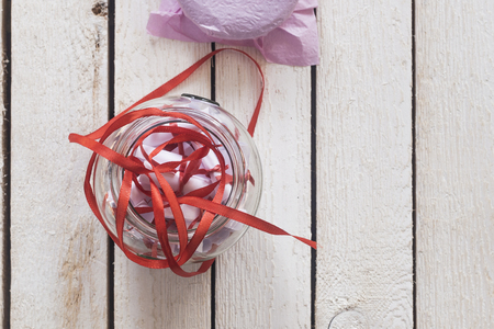 Valentine's day concept. Opened Date Jar with desires or wishes on wooden backgroundの写真素材