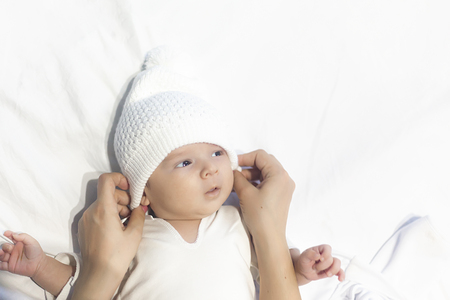 Little cute newborn baby in the arms of his motherの写真素材