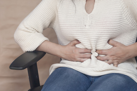 Portrait of menstruation pain. Female anatomy. Stomach pain. Sick woman sufferingの写真素材