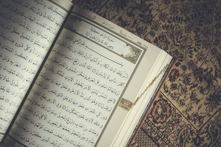 The Holy Quran on praying carpet. Flat lay view of Quran. Top viewの写真素材