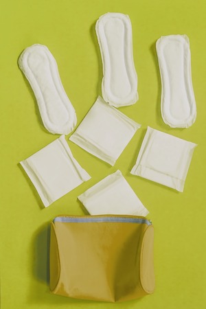 Women's bag and sanitary napkins on the blue backgroundの写真素材