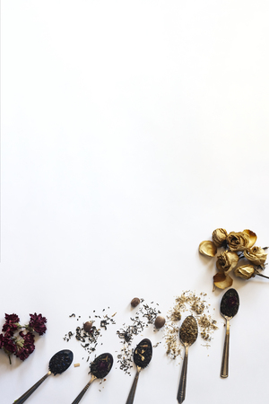 The assortment of dry tea. Different types of herbal tea for wellness. Dry tea leaves on white. Variety of dry tea in spoons on the white backgroundの写真素材