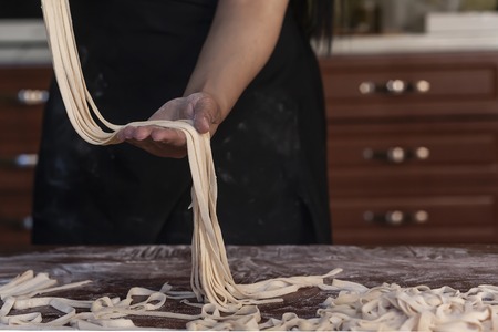 Young house wife preparing the homemade pasta at kitchenの写真素材