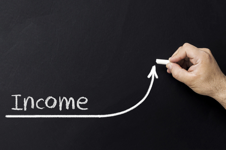 Growing income concept. Businessman draw accelerating line of improving incomeの写真素材