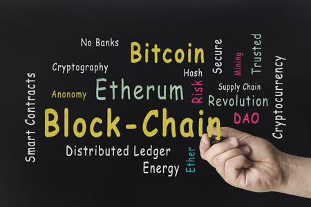 Hand writing word cloud. Cryptocurrency, finance, online business, blockchain concept against the blackboard.の写真素材