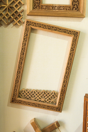 Wood frame on the wall. Wooden frame with middle eastern ornament decorations hanging on the wallの写真素材