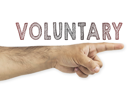 volunteering concept. Hand pointing to voluntary inscription on white backgroundの写真素材