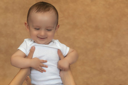 Mother and baby. Mom holding her 6 months baby boy. Beautiful baby boy of six months in his mother's...