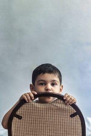 Portrait of a 6-year-old boy. Vertical image with free space. Cute six-year-old middle eastern boy portraitの写真素材