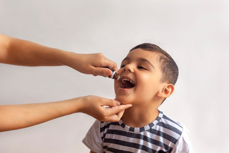 Child immunization with little drop in clinic. Doctor providing immunization vaccines for the immune...