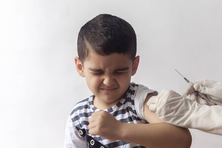A doctor vaccinating young patient. Little boy scared of injection. Child's Immunization, Children's Vaccination, Health conceptionの写真素材