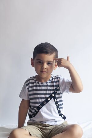 Six years boy portrait. Innocent smiling little boy on grey background. Little kid having fun. People, childhood lifestyle concept.の写真素材