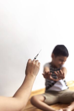 A doctor vaccinating young patient. Little boy scared of injection. Child's Immunization, Children's Vaccination, Health conceptionの写真素材