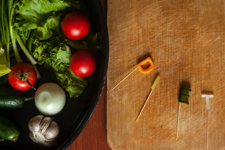 Diet word made cut from vegetables and dish of fresh vegetables. Fresh and healthy food concept.
